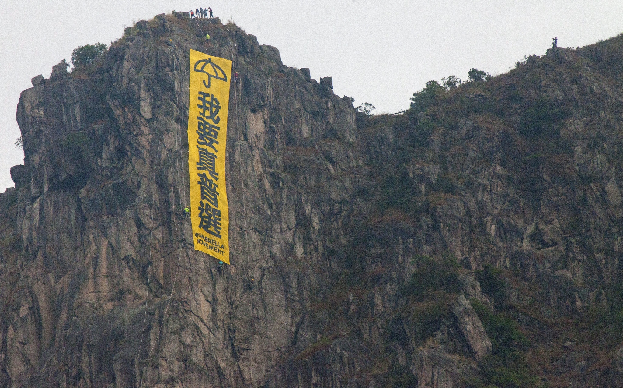 A banner calling for universal suffrage hangs on the iconic Lion Rock. Photo: EPA