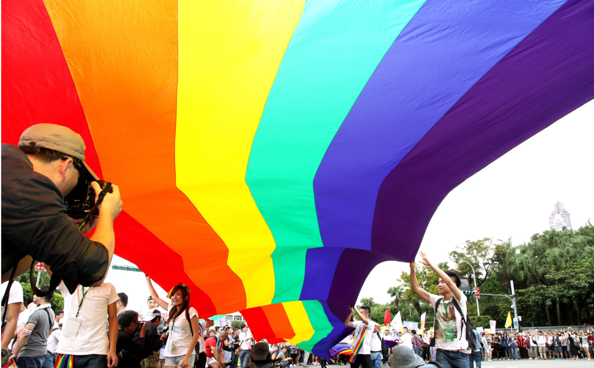 Revellers hold up a giant rainbow flag during the 12th annual Taipei Gay Pride march in Taipei on Saturday. Photo: EPA