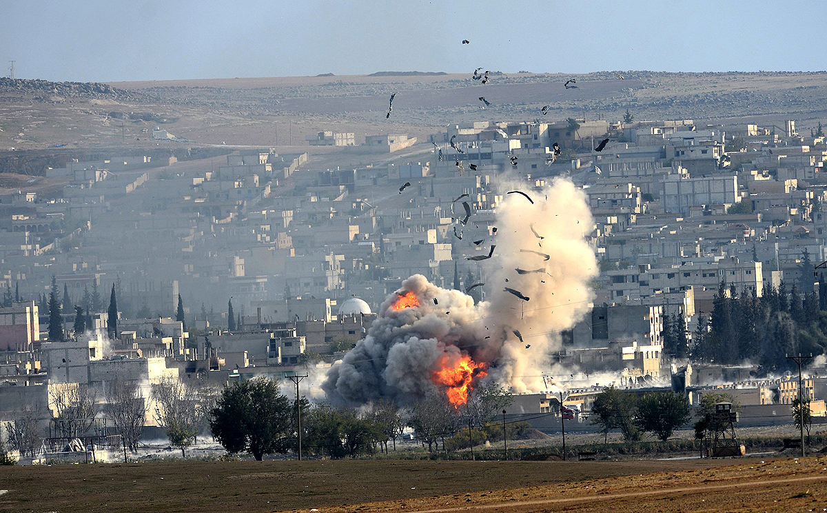 An explosion after an apparent US-led coalition airstrike on Kobane, Syria, as seen from the Turkish side of the border. Photo: EPA