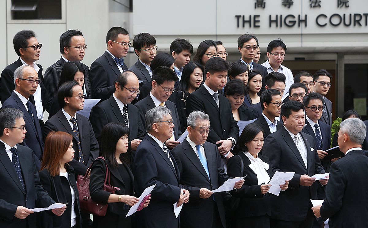 Lawyers stand in silence outside the High Court to condemn those ignoring temporary court injunctions taken out to stop people blocking roads as part of the ongoing Occupy Central civil disobedience movement on November 3. Photo: Sam Tsang