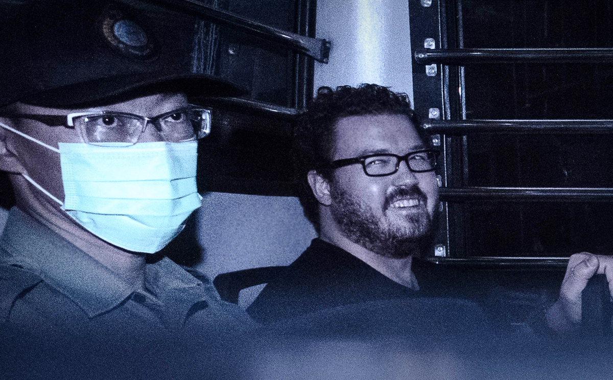 British banker Rurik Jutting smiles as he leaves court yesterday after his double-murder case was adjourned for two weeks. Photo: AFP