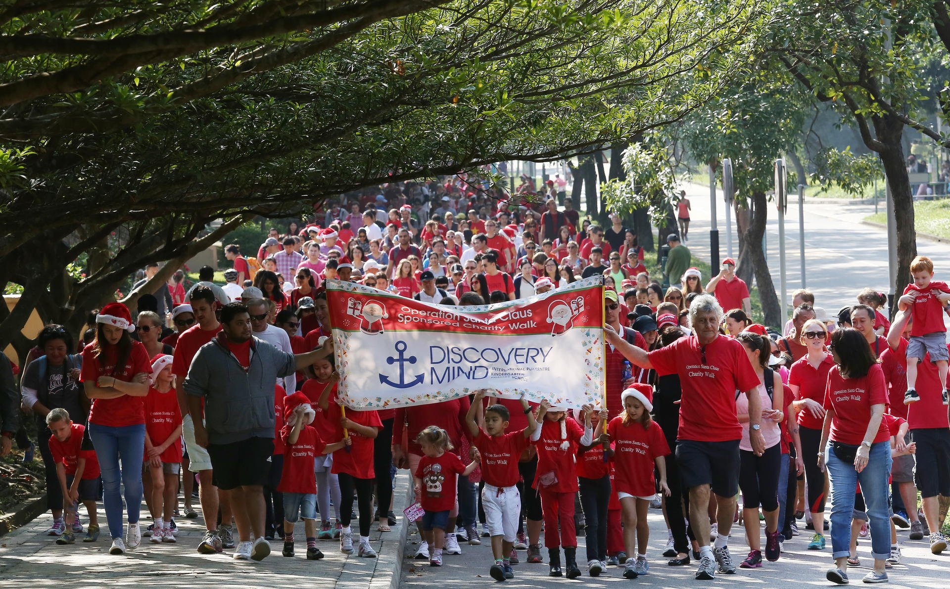 Children from Discovery Mind kindergarten and their parents take the Operation Santa Claus stroll yesterday. Photo: Jonathan Wong