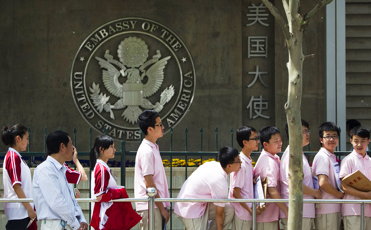 Chinese students wait outside the US embassy in Beijing for their visa application interviews. Photo: AP