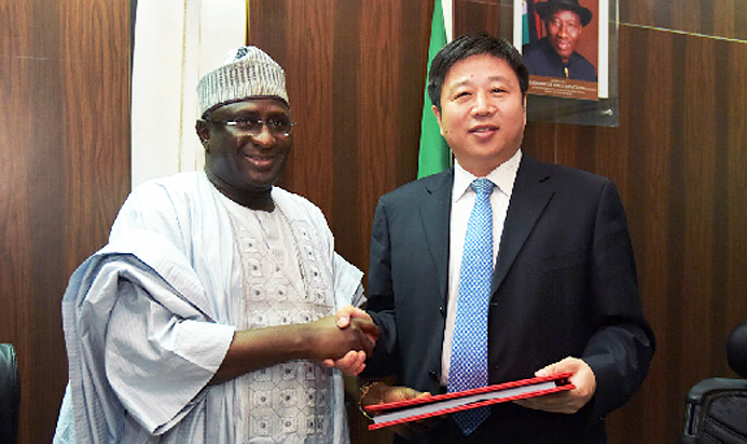 Cao Baogang (right), vice-president of China Railway Construction Corporation (CRCC) China-Africa Construction Limited, shakes hands with Nigeria's Transport Minister, Idris Audu Umar, after signing a contract for a railway project in Nigeria in Abuja on November 19, 2014.