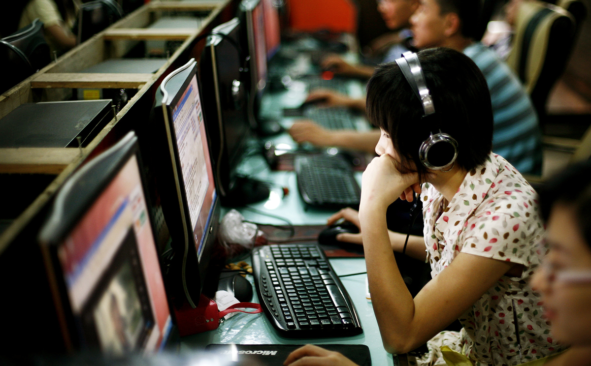 Customers surf the web at an internet cafe in Beijing. Photo:  AP