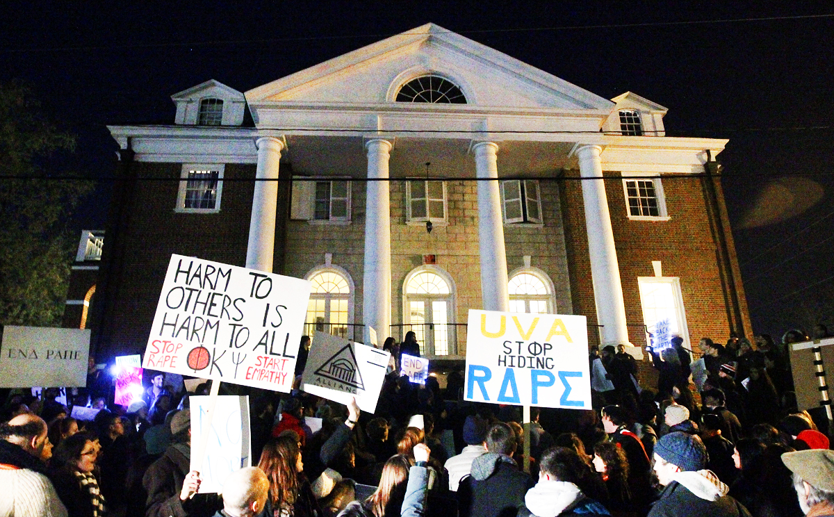Protestors carry signs and chant slogans in front of the Phi Kappa Psi fraternity house at the University of Virginia. Photo: AP