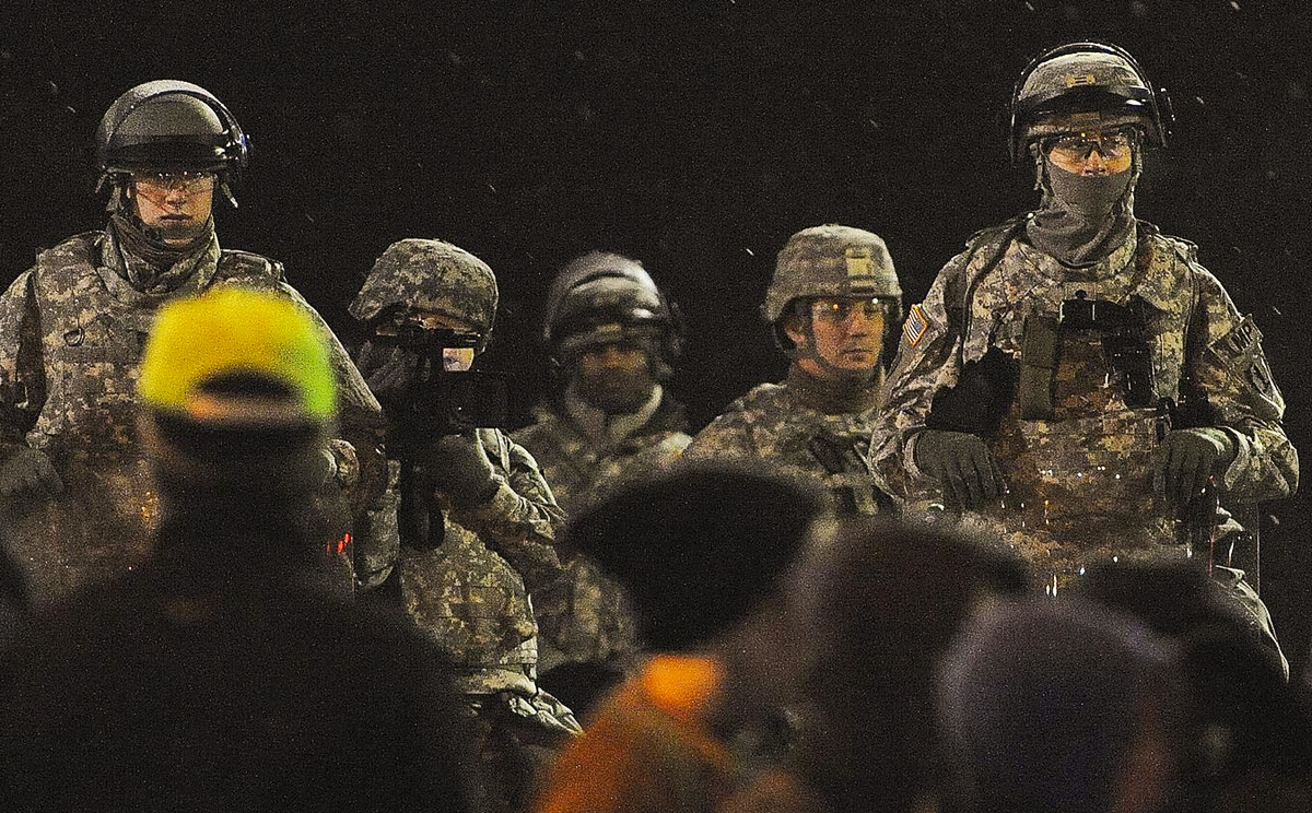 The National Guard patrols outside the Ferguson Police Department. Photo: AFP