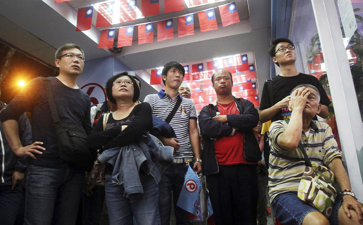 The tension of yesterday’s local elections in Taiwan shows on the faces of supporters of the Democratic Progressive Party as they watch results roll in. Photo: AP
