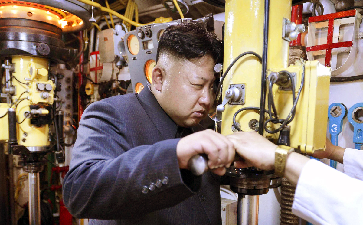 North Korean leader Kim Jong-un peers through a periscope of a submarine during an inspection of the Korean People's Army Navan Unit in June. Photo: Reuters