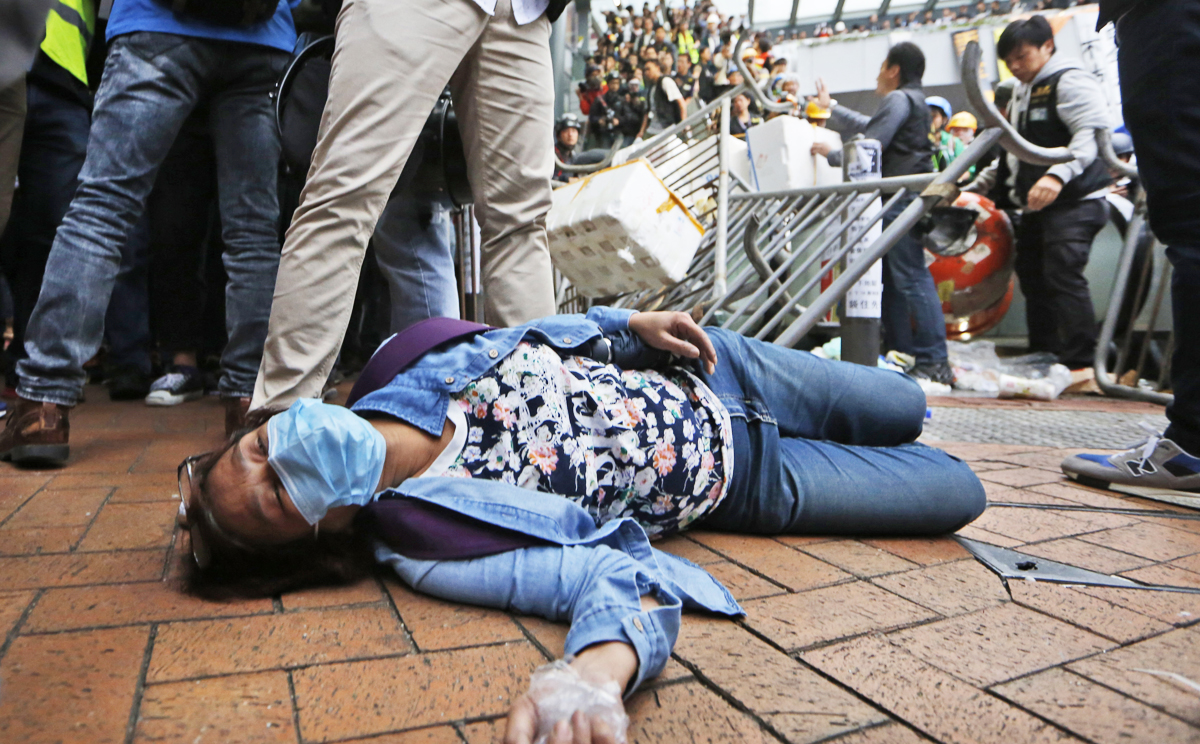 An injured protester lies on the ground during clashes on Monday. Photo: AP