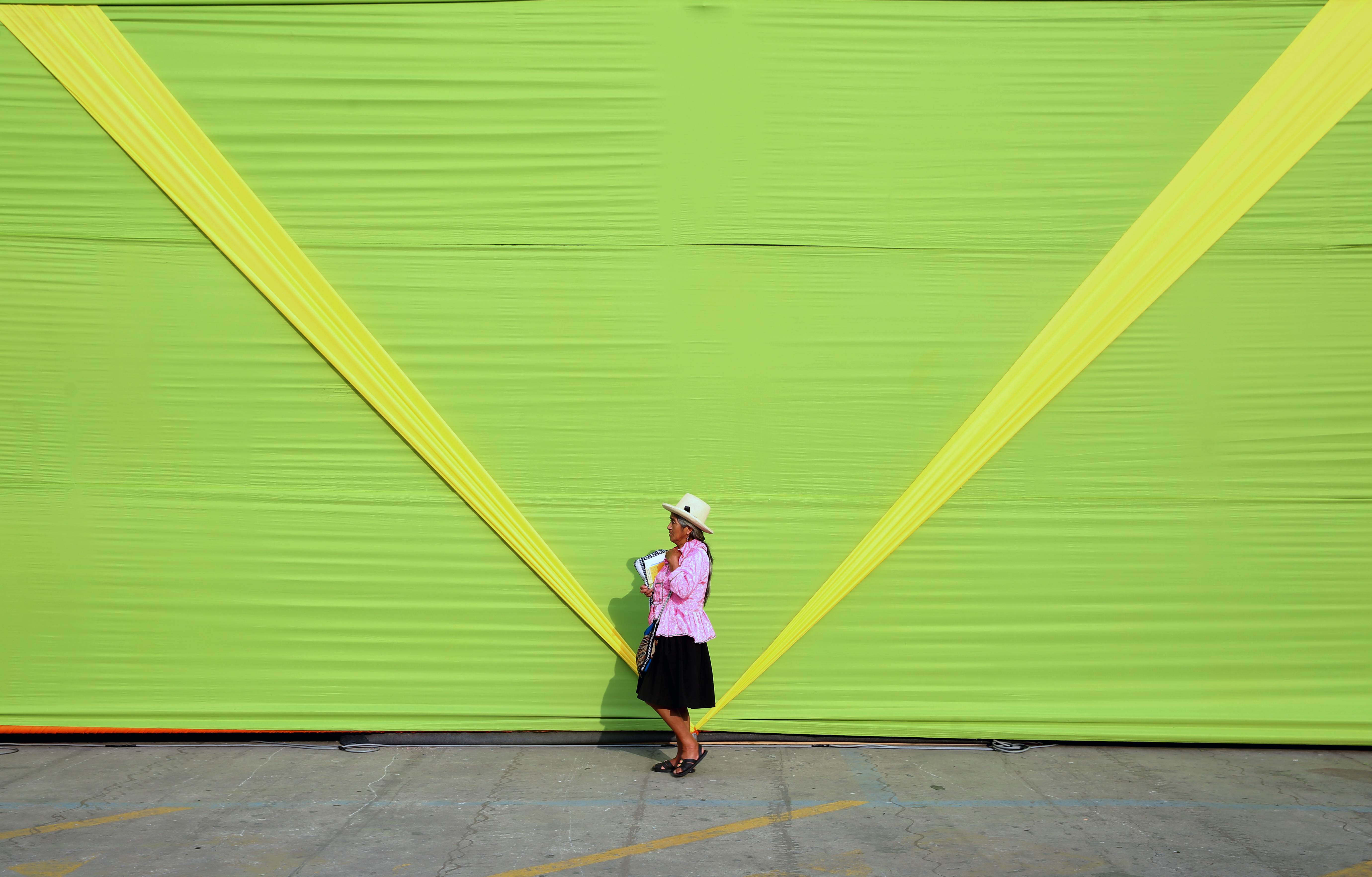 A woman wearing typical Andean attire walks past the installations being prepared for an event that's part of the UN climate conference in Lima. Photo: AFP 