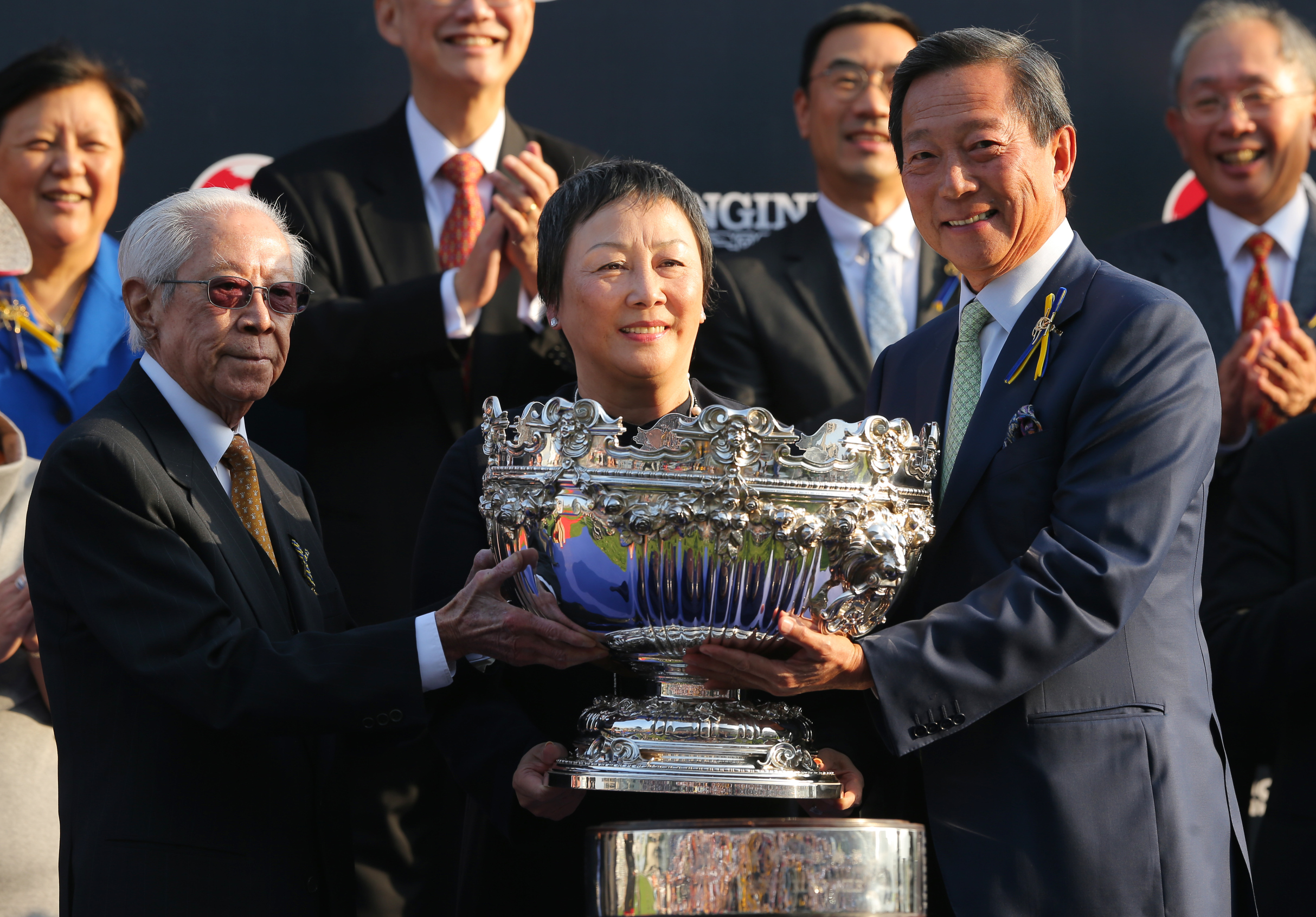 Cornel Li receives the Hong Kong Mile trophy from Jockey Club chairman Simon Ip Sik-on. Photo: Kenneth Chan