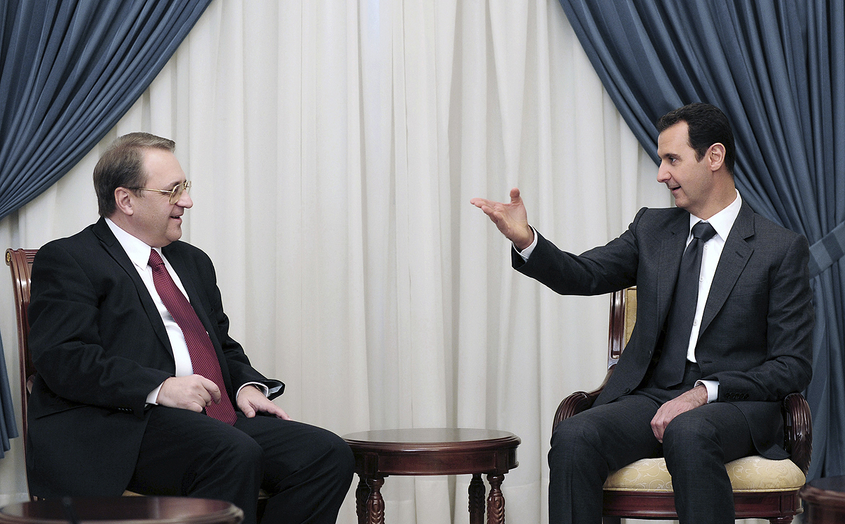 Syrian President Bashar Assad, right, speaks with Russia's deputy Foreign Minister Mikhail Bogdanov in Damascus, Syria earlier this month. Photo: AP