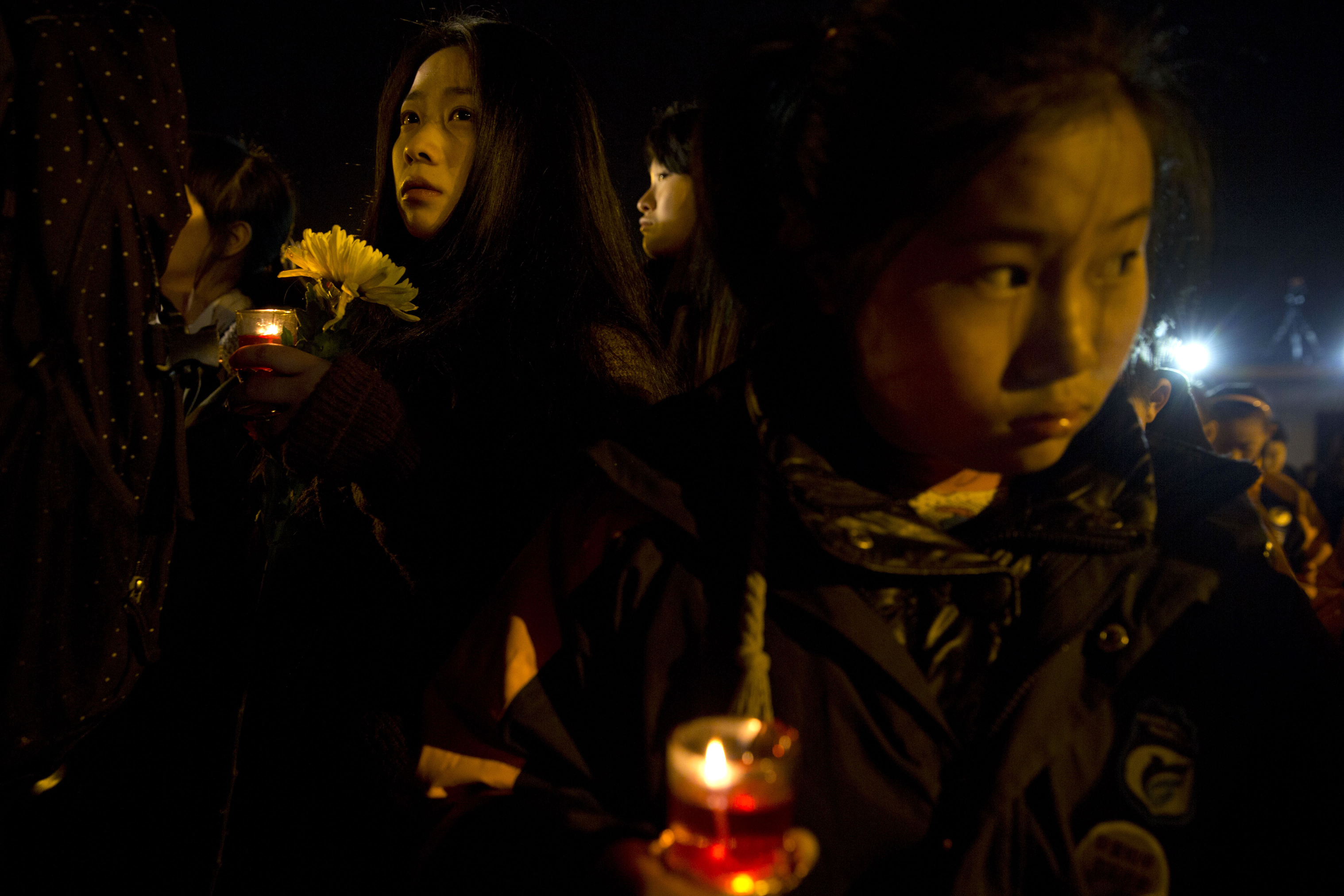 Chinese women attend a candlelight vigil in Nanjing, Jiangsu, in December to mark the Japanese invasion 77 years ago. Photo: AP