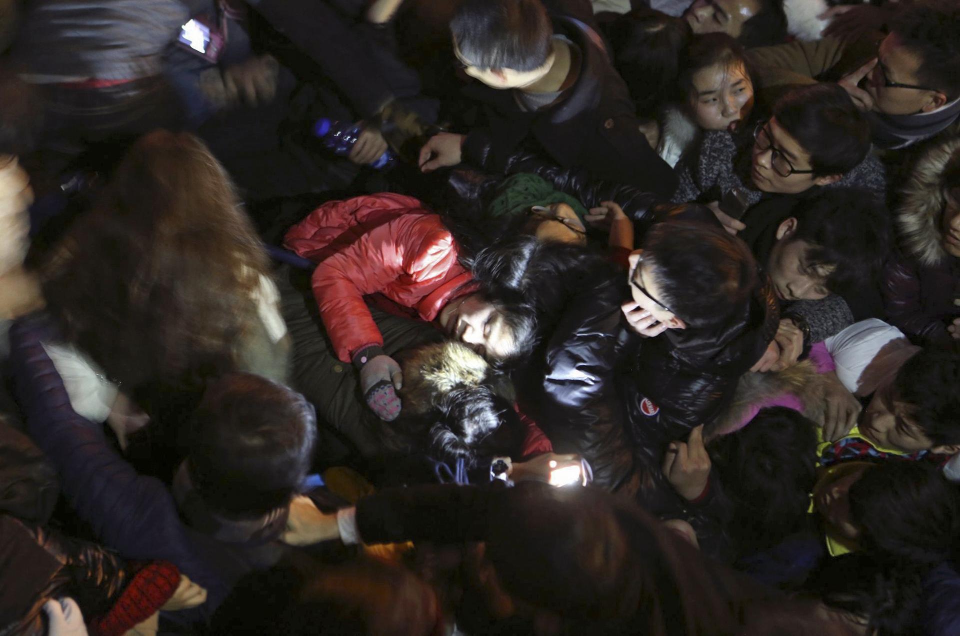 Revellers try to escape the crush in Shanghai. Photo: Reuters