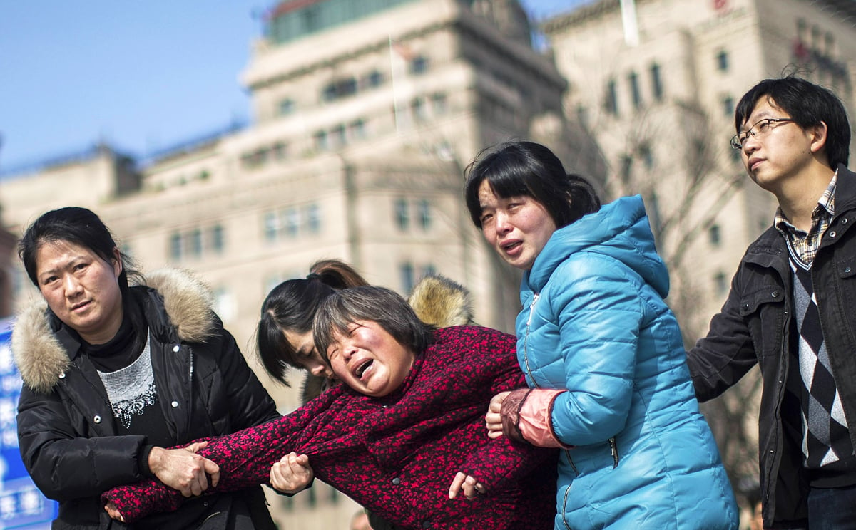A woman cries as she mourns her relative, a victim who was killed in a stampede during the new year celebrations on the bund, in Shanghai. Photo: Reuters