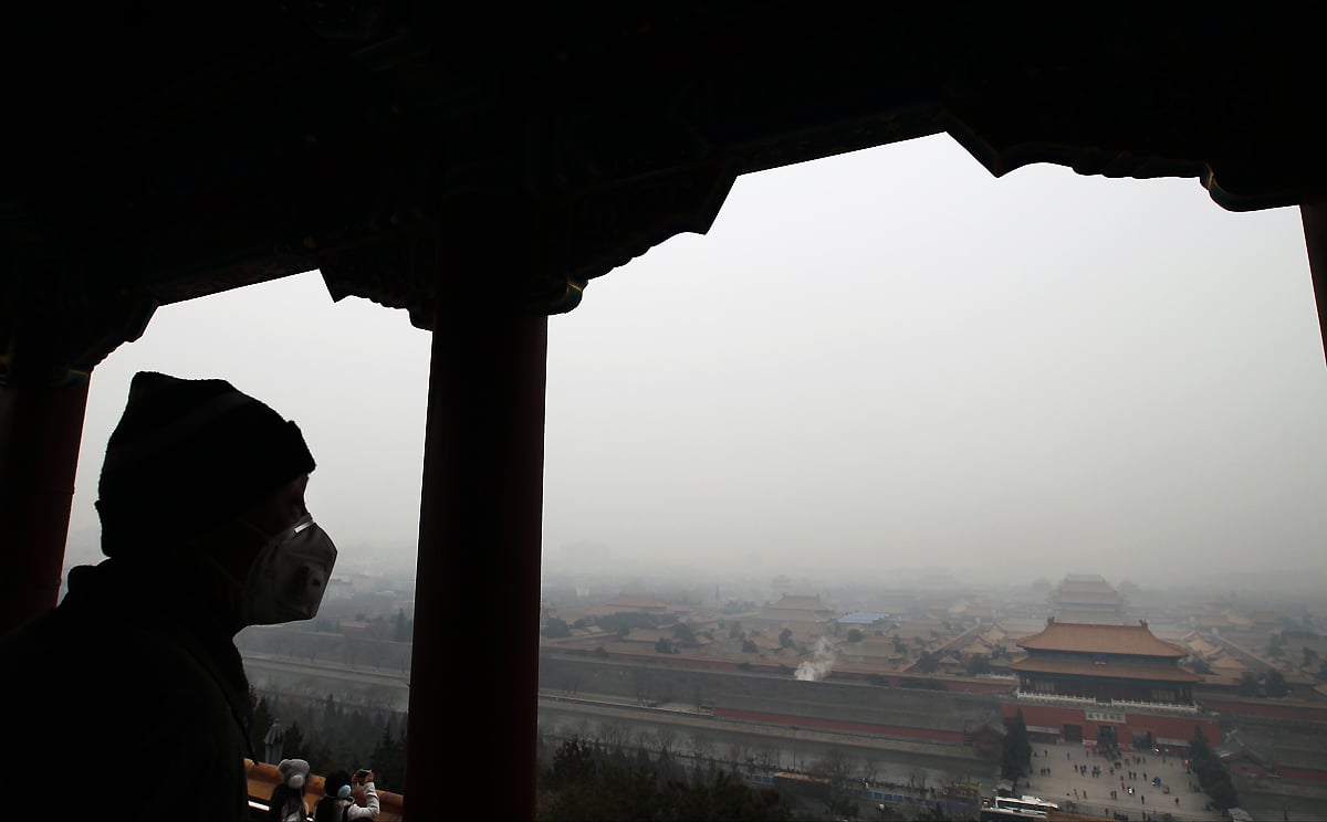 A man surveys the Forbidden City in Beijing on Wednesday as air quality in the capital descended to heavily polluted levels. Photo: Simon Song