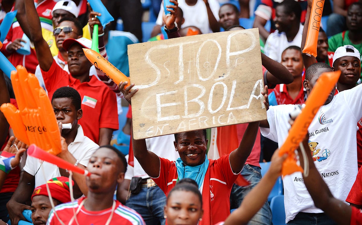 A football fan holds a placard reading 'Stop Ebola in Africa' ahead of the African Cup of Nations  match between hosts Equatorial Guinea and Congo at Bata Stadium on Saturday. Photo: AFP