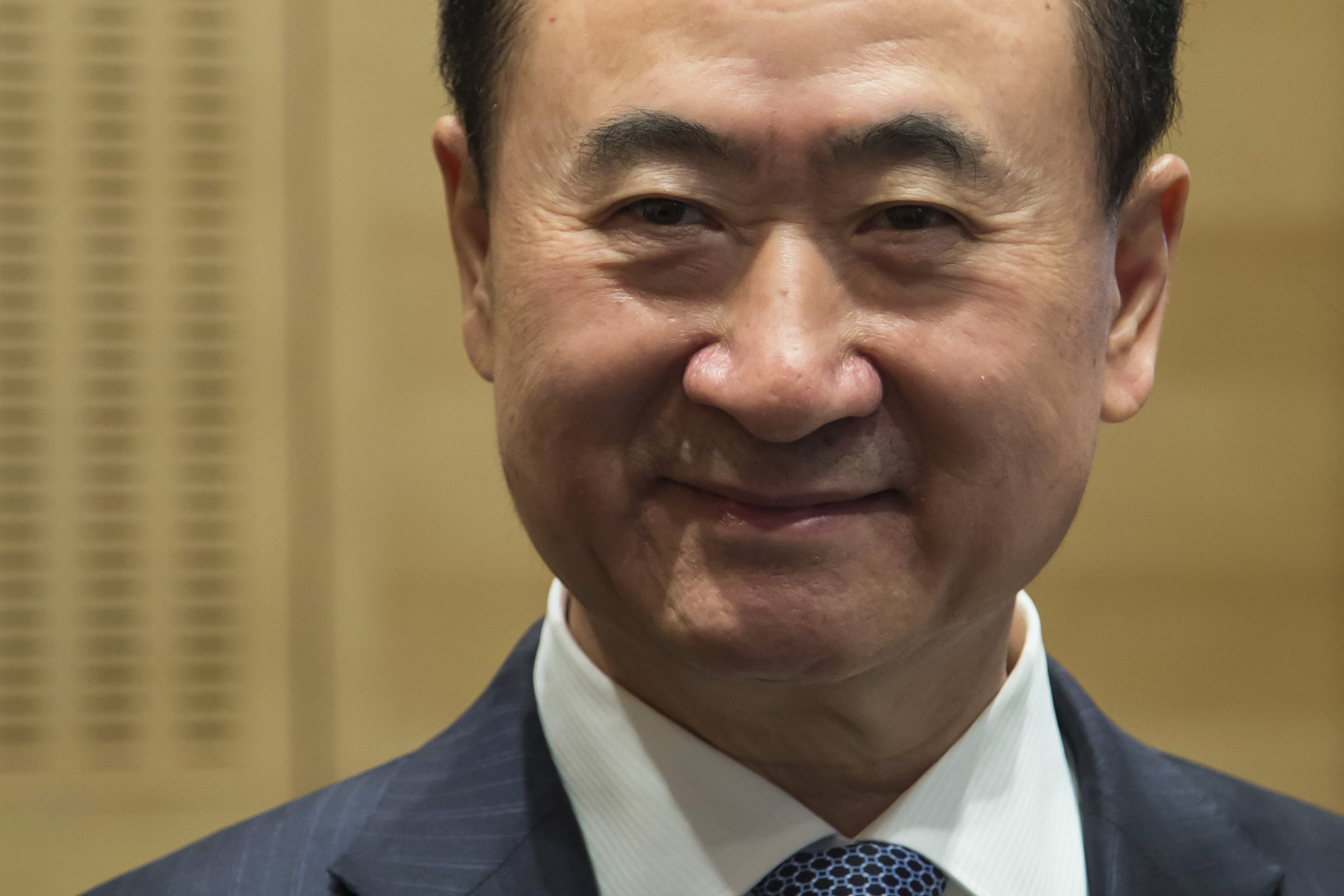 Wang Jianlin, chairman of Wanda commercial properties, attends a ceremony during the debut of the company at the Hong Kong Stock Exchange December 23, 2014. Photo: Reuters