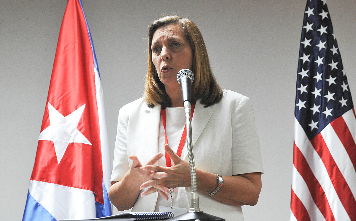Director of the North American Department of the Foreign Ministry, Josefina Vidal stands between Cuban and US flags as she delivers a speech in Havana on Thursday. Photo: AFP 