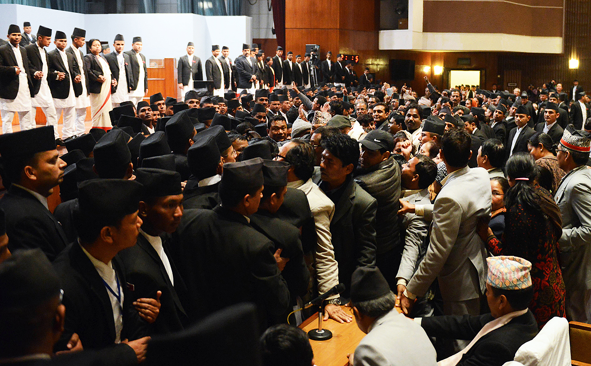 Nepalese opposition lawmakers, surrounded by parliament security officials, prevent a vote on disputed issues in the constitution. Photo: AFP