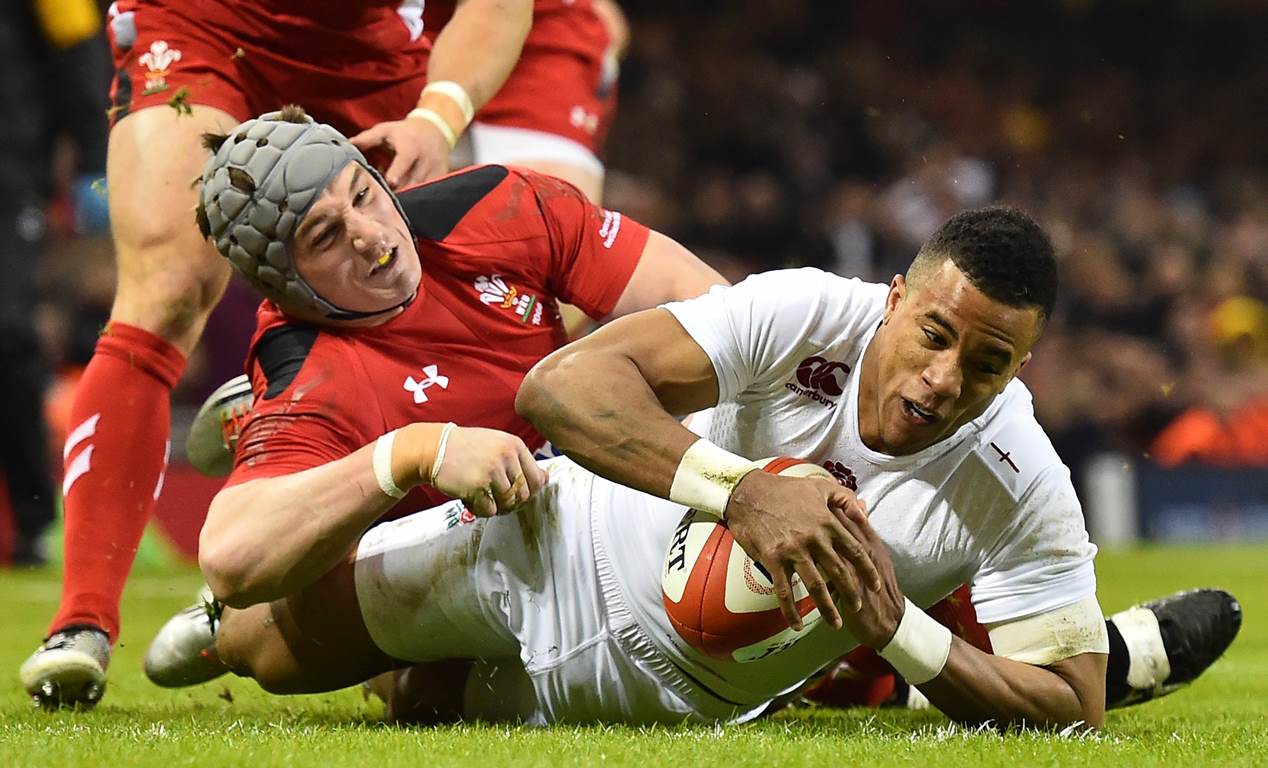 Winger Anthony Watson scores a try for England during their opening Six Nations Championship clash with Wales on Friday at the Millennium Stadium in Cardiff. England won the match 21-16. Photos: AFP