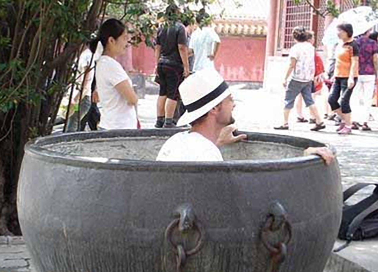 A tourist steps into a precious monument to pose for a photo. Photo: SCMP Pictures