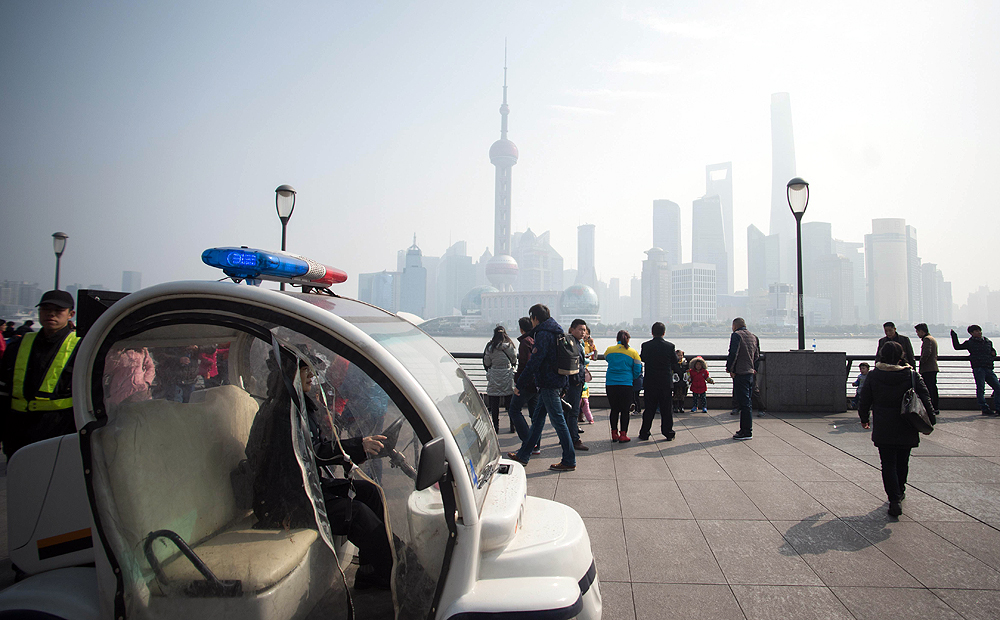 A police officer patrols along the promenade on the Bund. Photo: AFP

