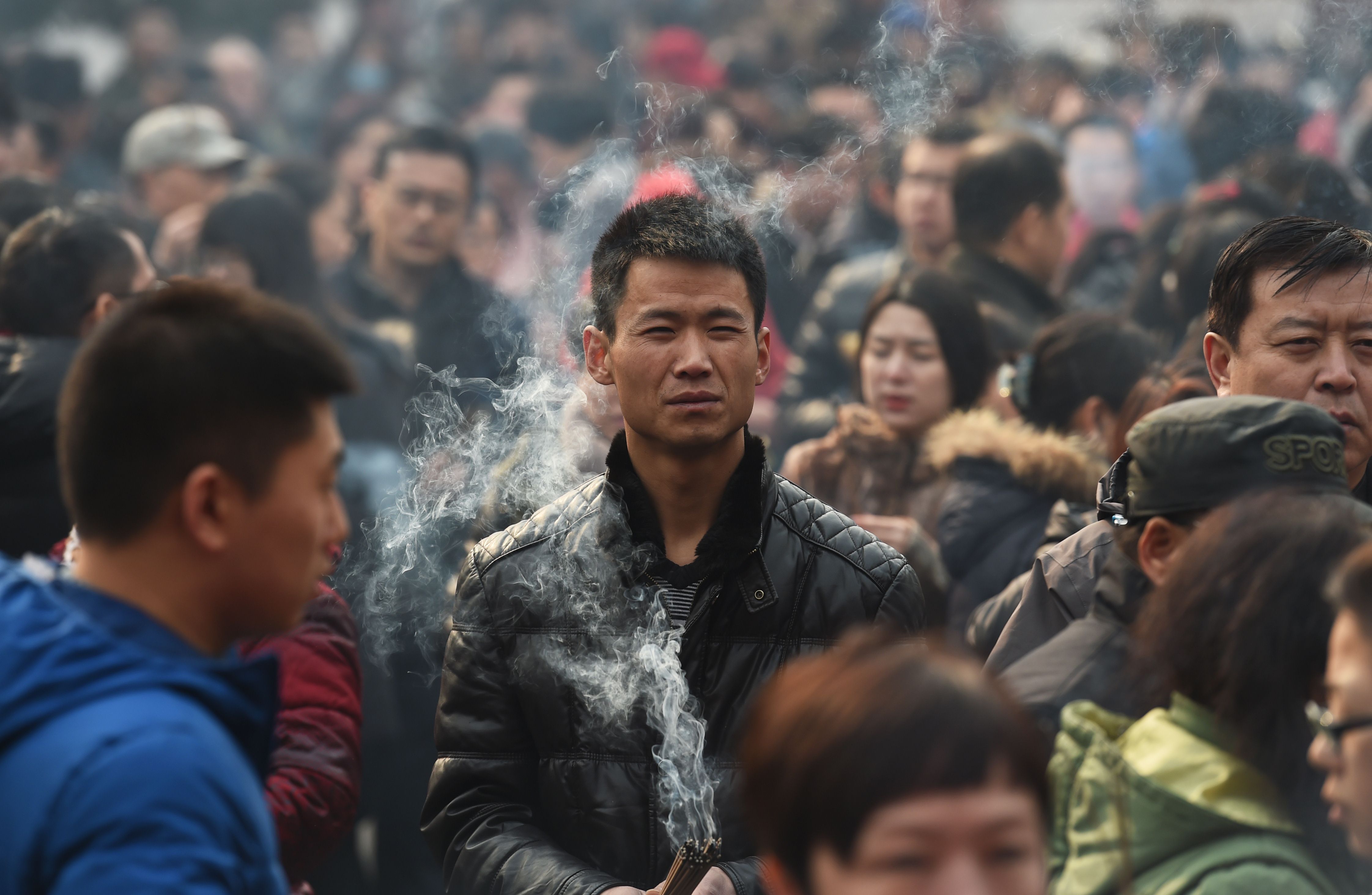 Worshippers pray in Beijing on the first day of the Lunar New Year. The vast majority of Chinese people do not benefit from cutting ties with their own society. Photo: AFP