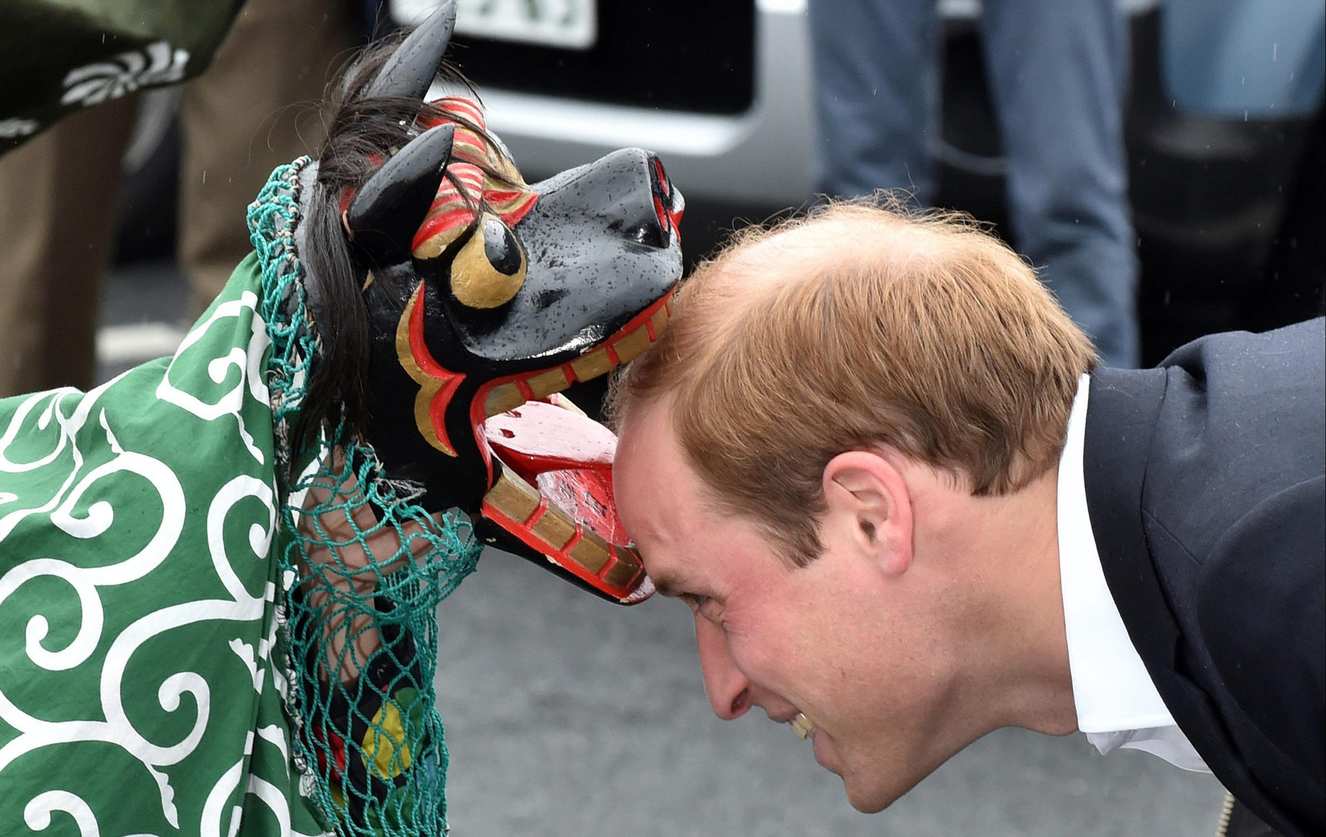 Prince William is greeted by a lion dancer. Photo: EPA