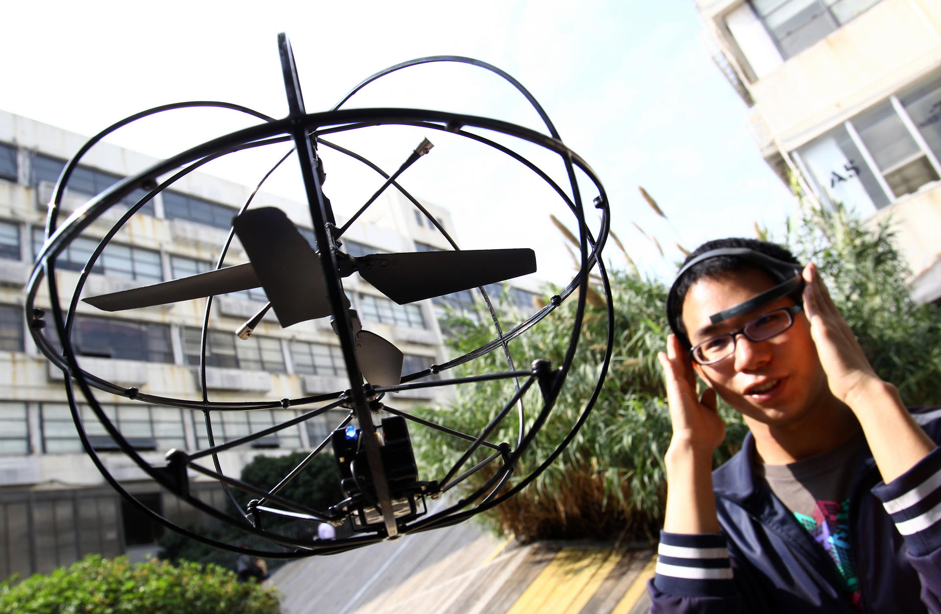 Sam Chen steers a "brain-controlled" Puzzlebox Orbit helicopter outside the Chaihuo maker space, a Shenzhen workshop for technology enthusiasts. Photo: Dickson Lee