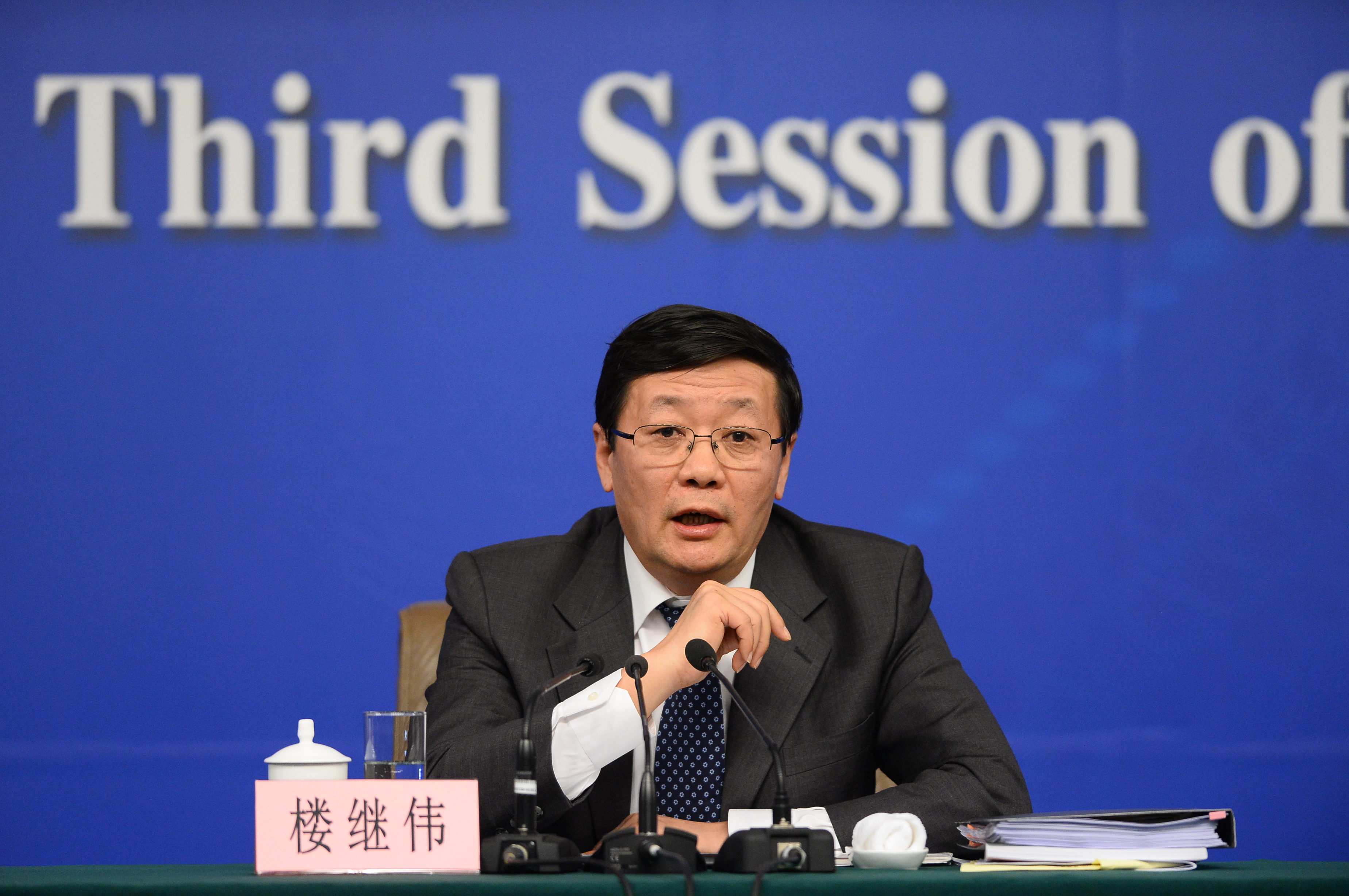 Lou Jiwei, China's Finance Minister, answers questions during a press conference today at the National People's Congress. Photo: Xinhua