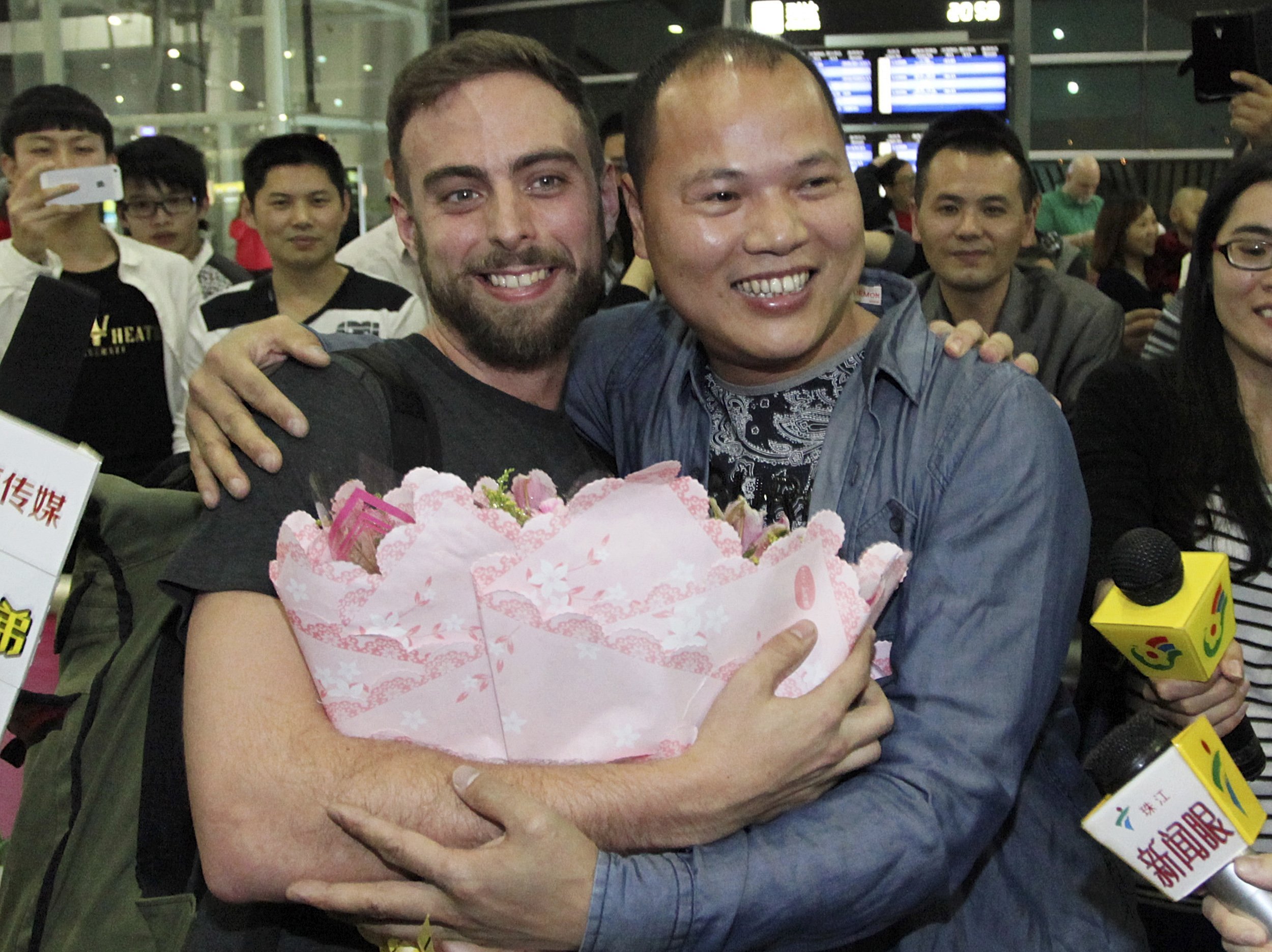 BuzzFeed's Matt Stopera is greeted by 'Brother Orange' at the Jieyang airport. Photo: Reuters