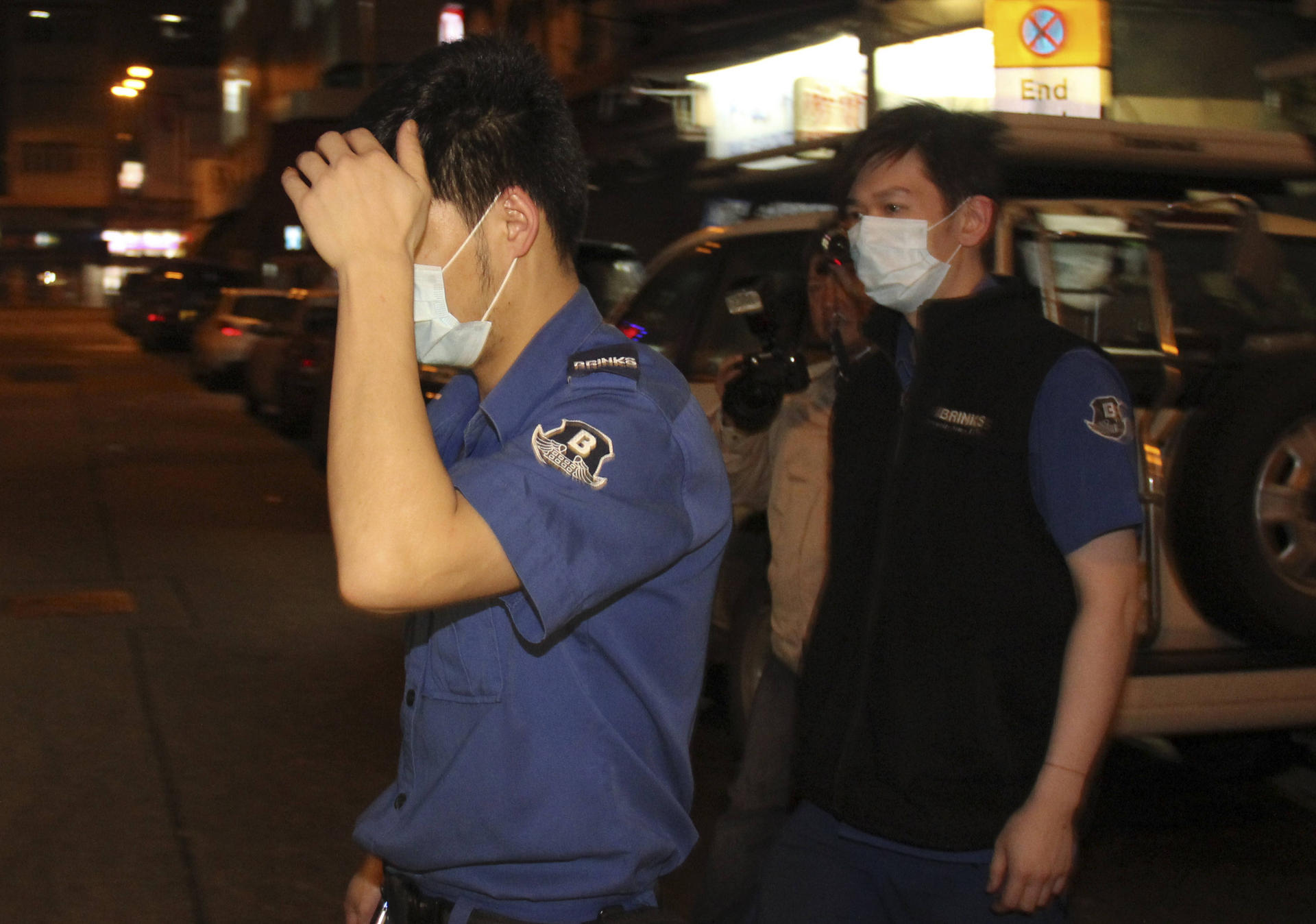A guard (left) apparently left his gun at an ATM. Photo: SCMP pictures