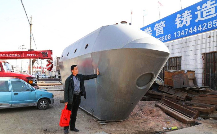Du Xiutang, 53, with his 300,000 yuan home-made submarine, which he says needs new investment if it is to set sail... and submerge ... as intended. Photo: SCMP Pictures