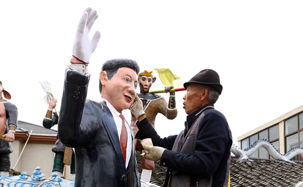 Chinese villager Zheng Hongkang, a keen amateur painter, adds a dash of colour to his life-sized clay model of President Xi Jinping. Photo: Dfic.cn 