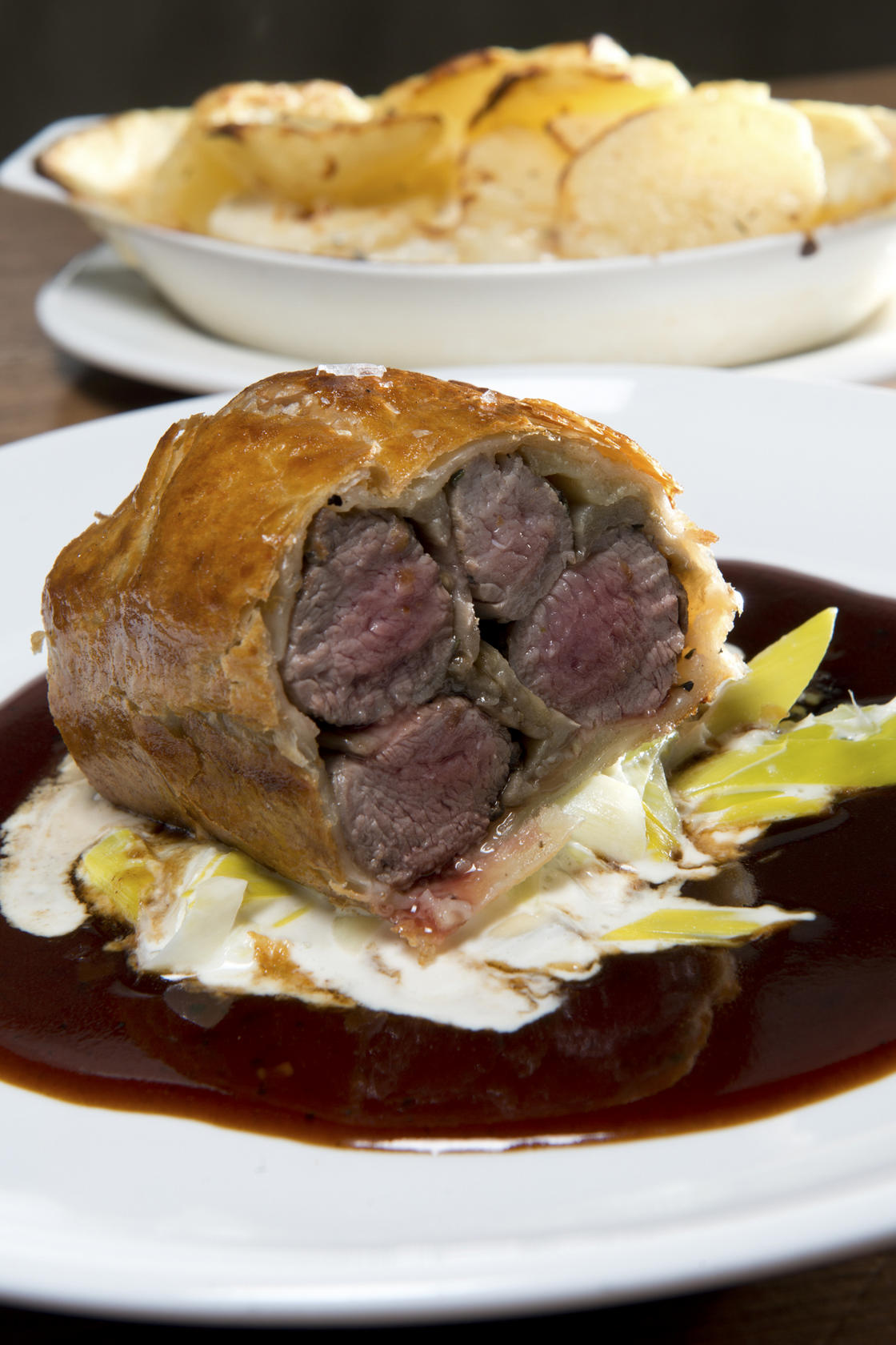 Orange Tree's lamb fillets and eggplant baked in puff pastry on creamed leeks and rosemary jus.