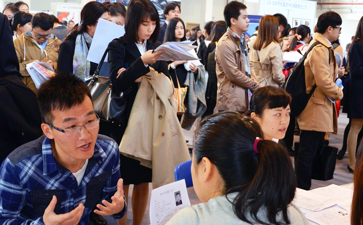 Companies hold a session for interviews with Chinese job seekers at a university in Beijing. Photo: Kyodo