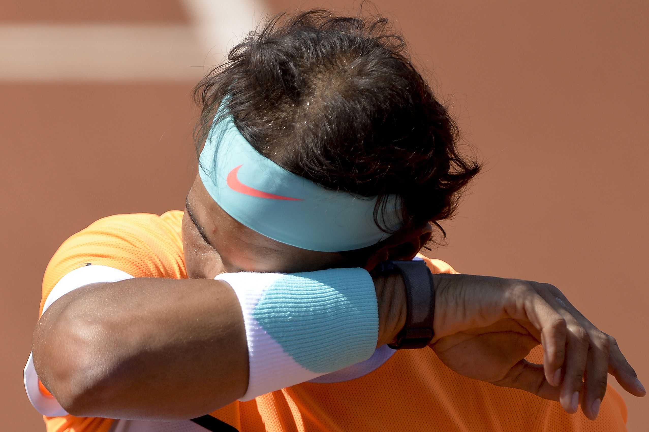 Spaniard Rafael Nadal wipes his head after a match against Italian tennis player Fabio Fognini at the "Conde de Godo" tennis tournament in Barcelona. Photos: AFP 