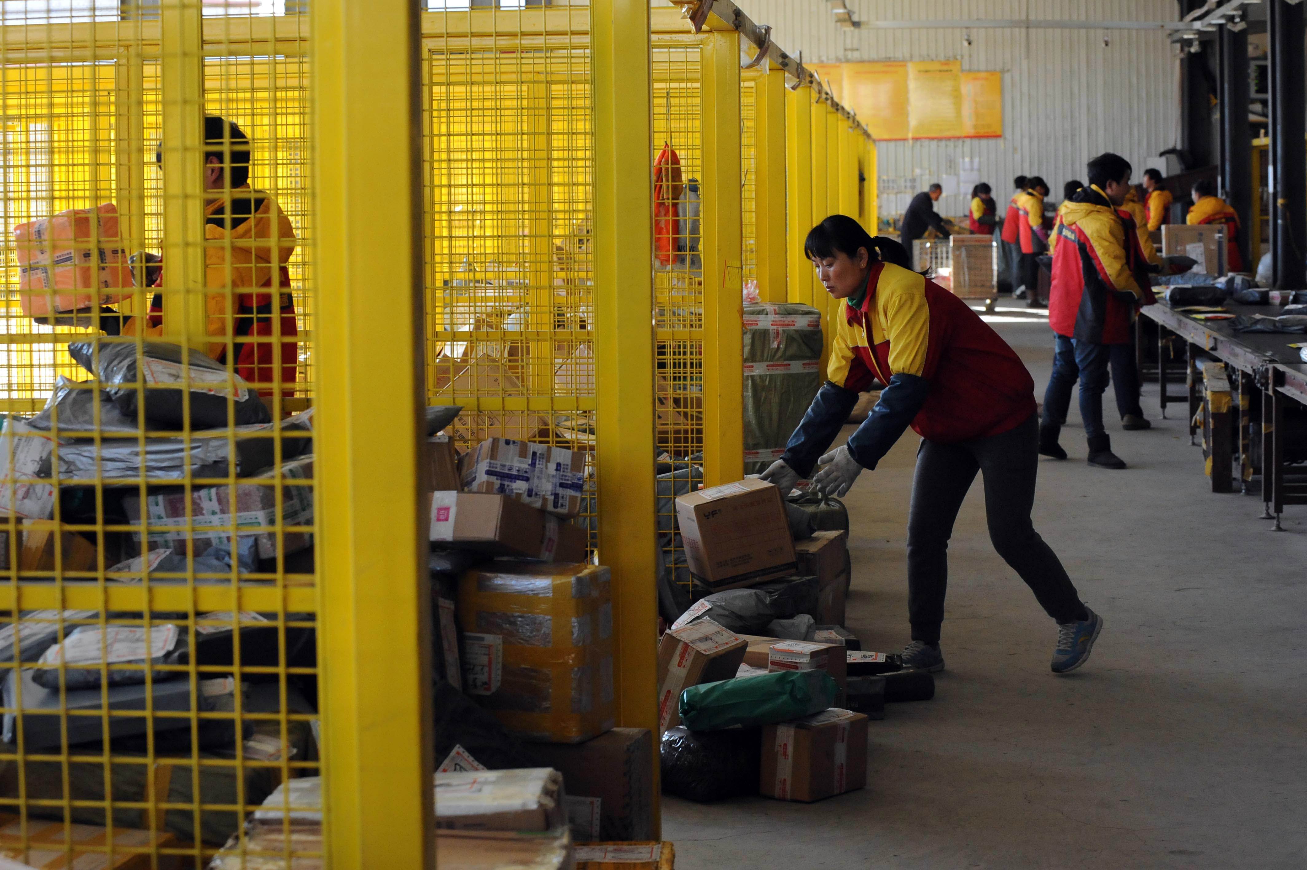 Logistics workers at a warehouse which supplies products to Alibaba's e-commerce platforms. Photo: AFP