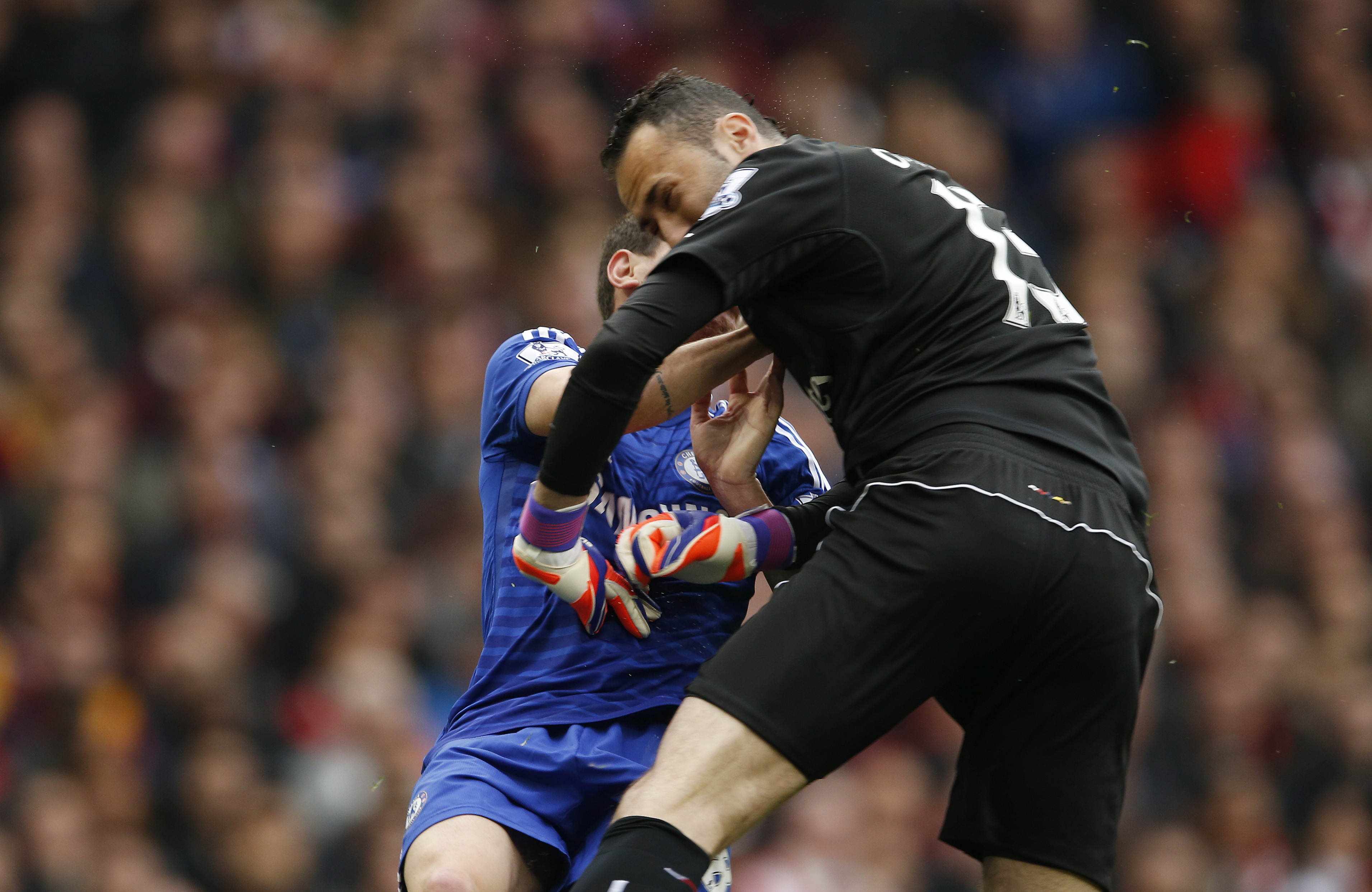 Chelsea's Oscar collides with Arsenal's David Ospina after shooting at goal. Photo: Reuters