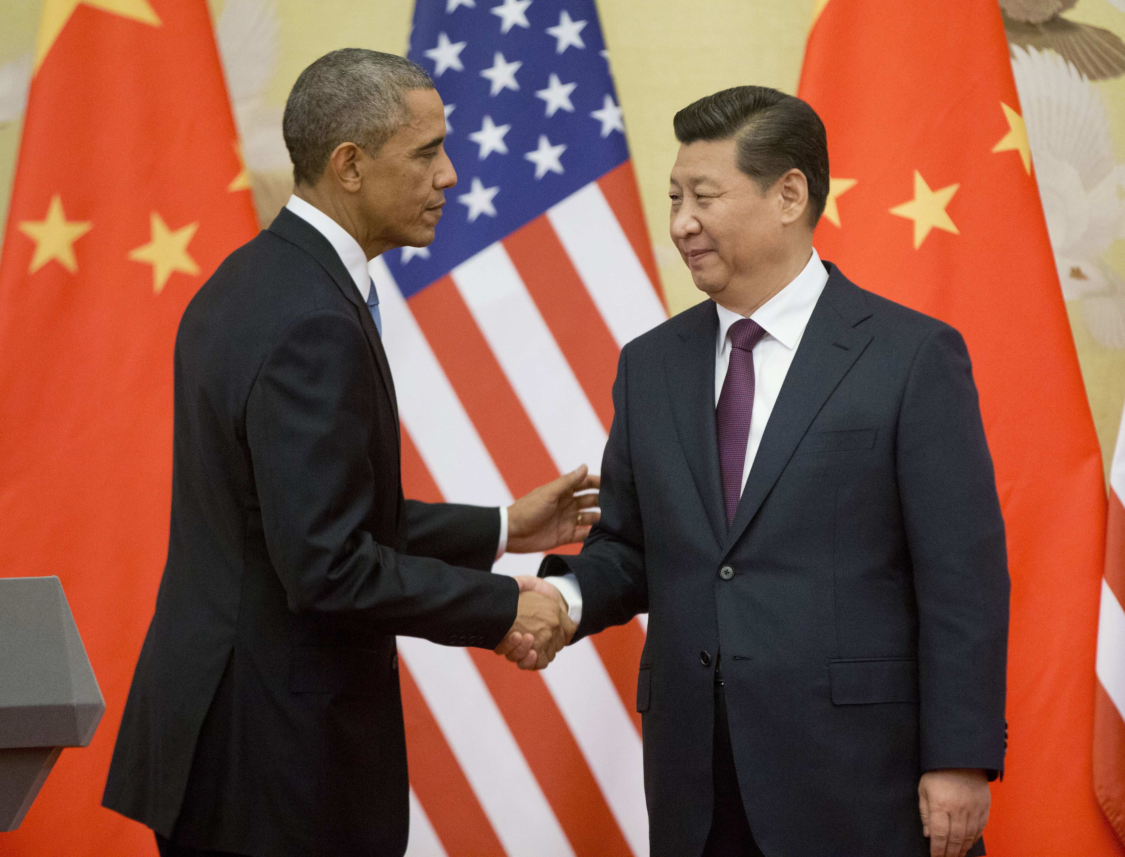 US President Barack Obama and Chinese President Xi Jinping shake hands after a meeting in Beijing last year. Both countries are still engaged in the 'great game' to advance their own interests as the two most powerful countries in the world. Photo: AP 