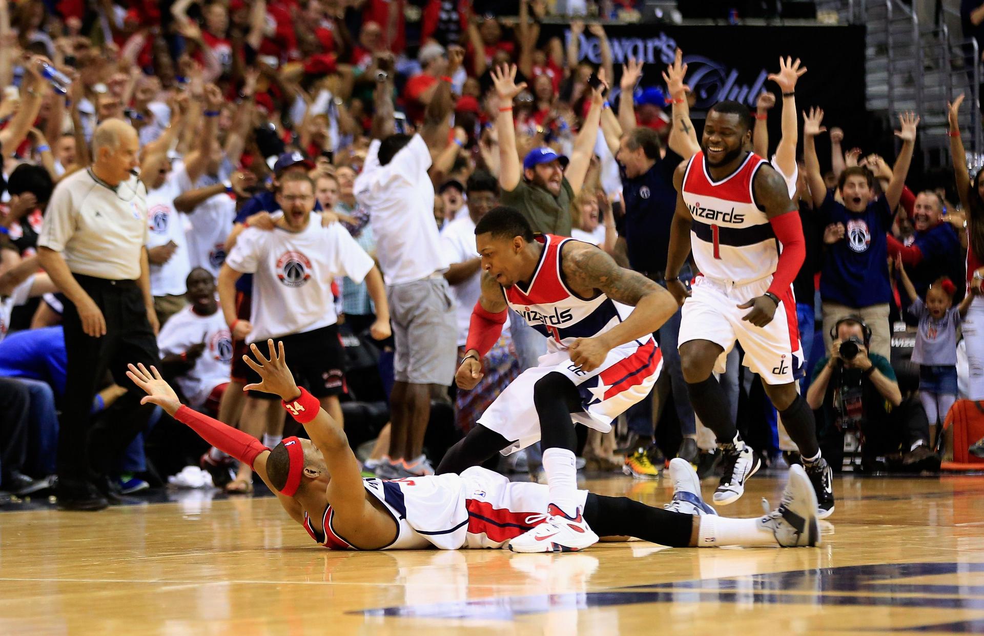 Paul Pierce, of the Washington Wizards, collapses to the floor to celebrate his winning shot with teammate Bradley Beal in their game against the Atlanta Hawks. Photo: AFP