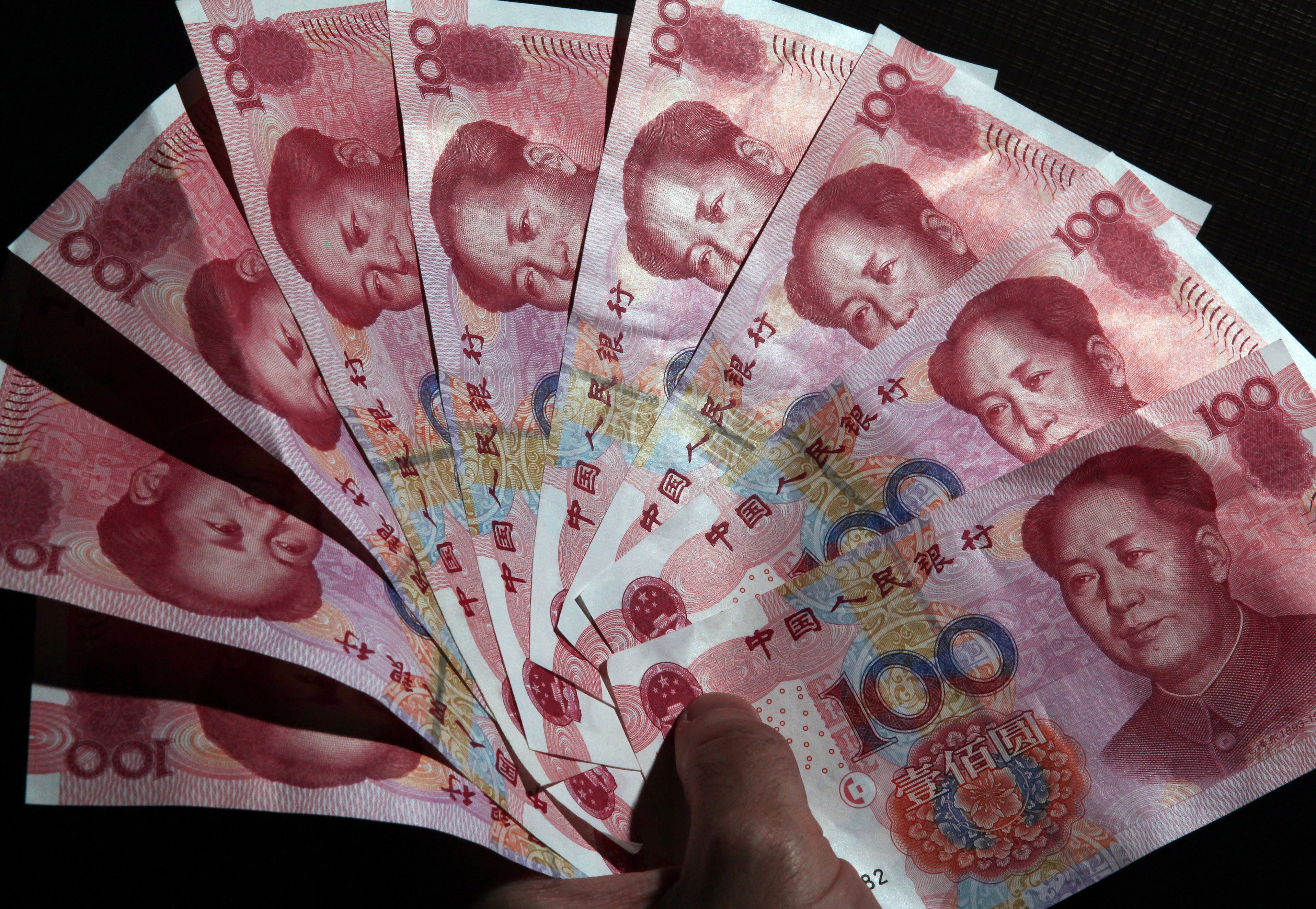 A semi-circle of Chinese yuan notes ad the currency's midpoint set by the People's Bank of China was set at its strongest in 15 months. Photo: EPA