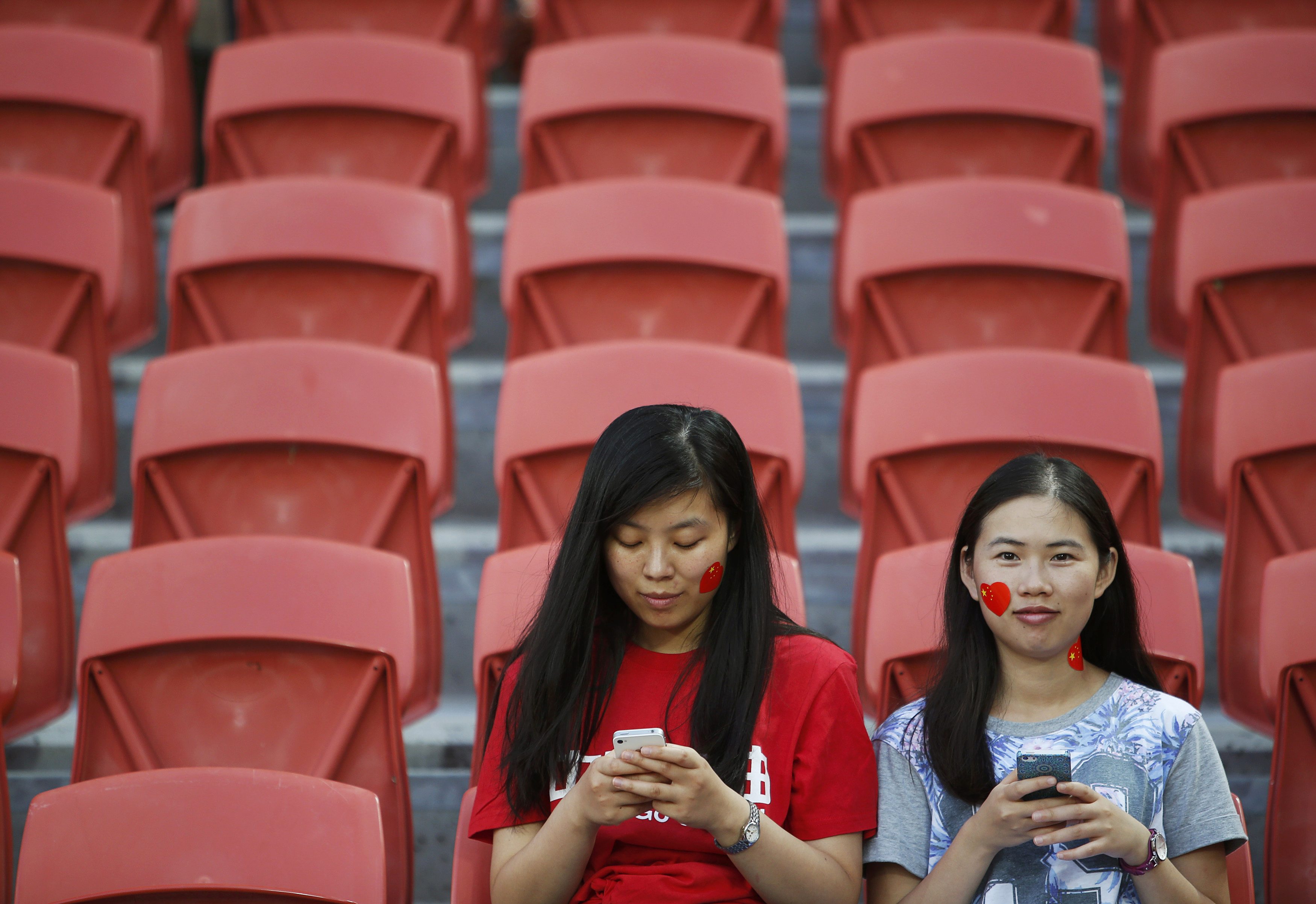 China fans use their mobile phones at a soccer match. Photo: Reuters