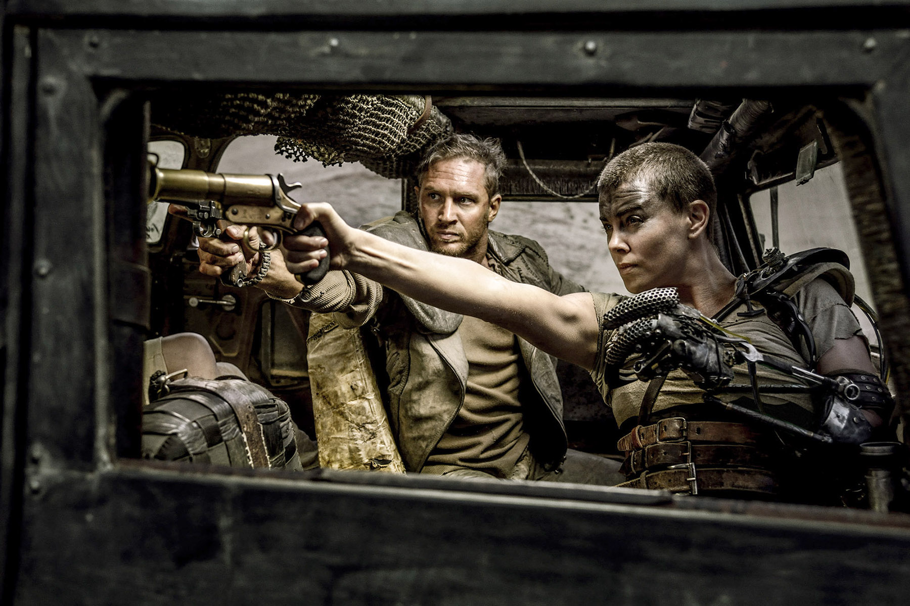 Max (left; played by Tom Hardy) and a one-armed woman warrior named Furiosa (Charlize Theron) try to outpace and outfox a psychotic gang sent by a cult leader. Photo: Washington Post