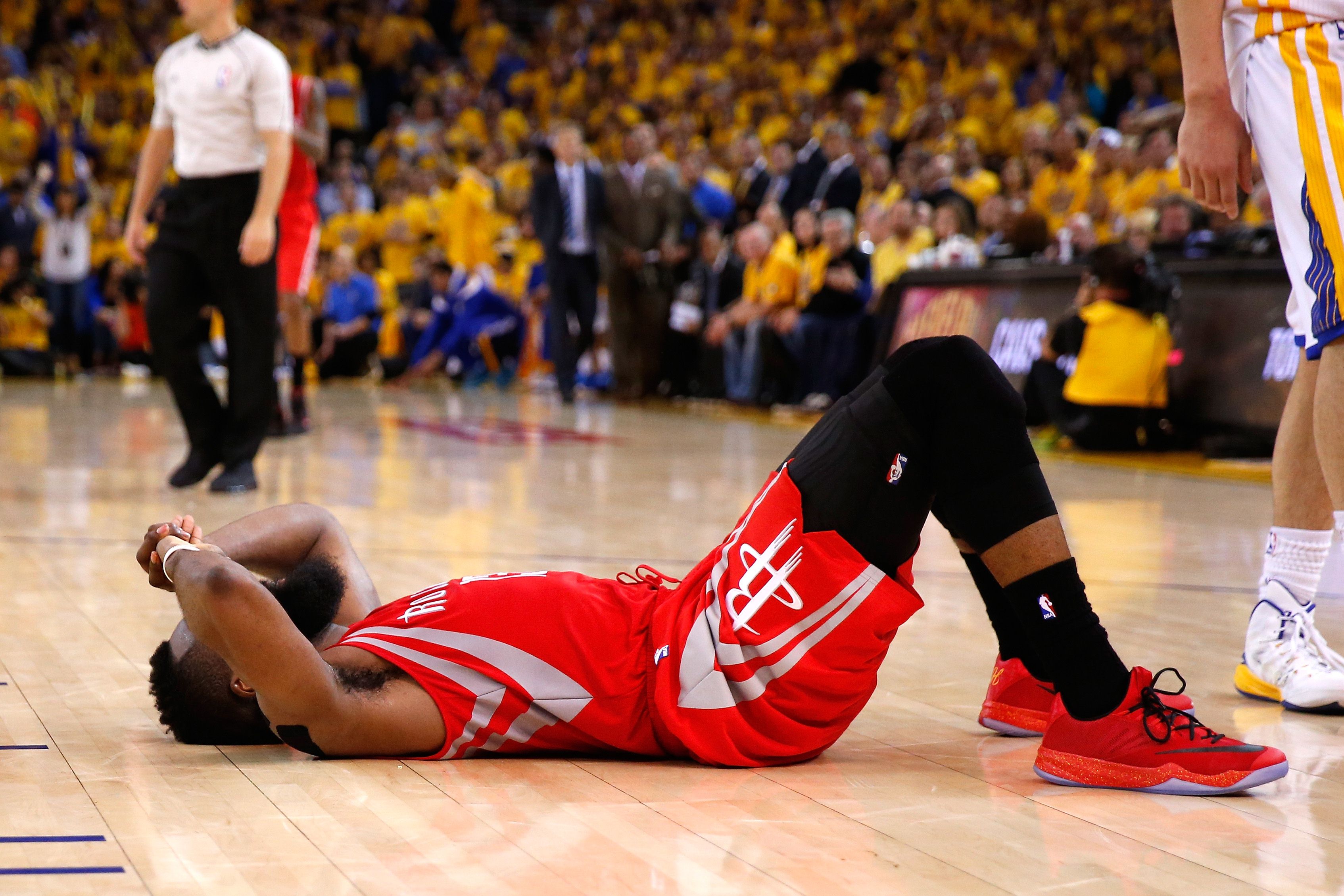 James Harden of the Houston Rockets lies slumped on the court after being denied a game-winning shot against the Golden State Warriors in game two of the Western Conference finals. Photo: AFP