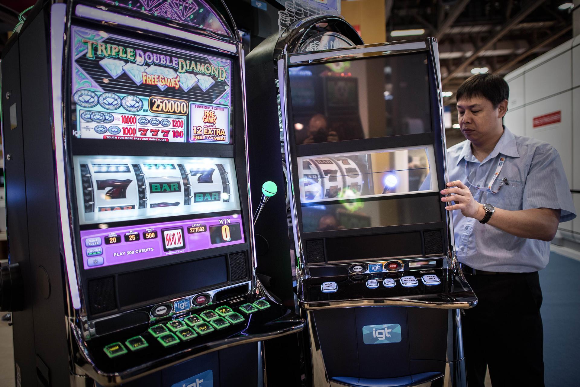 A technician checks slot machines at The Venetian in Macau. The machines have become dominant in casinos over the years. Photo: AFP