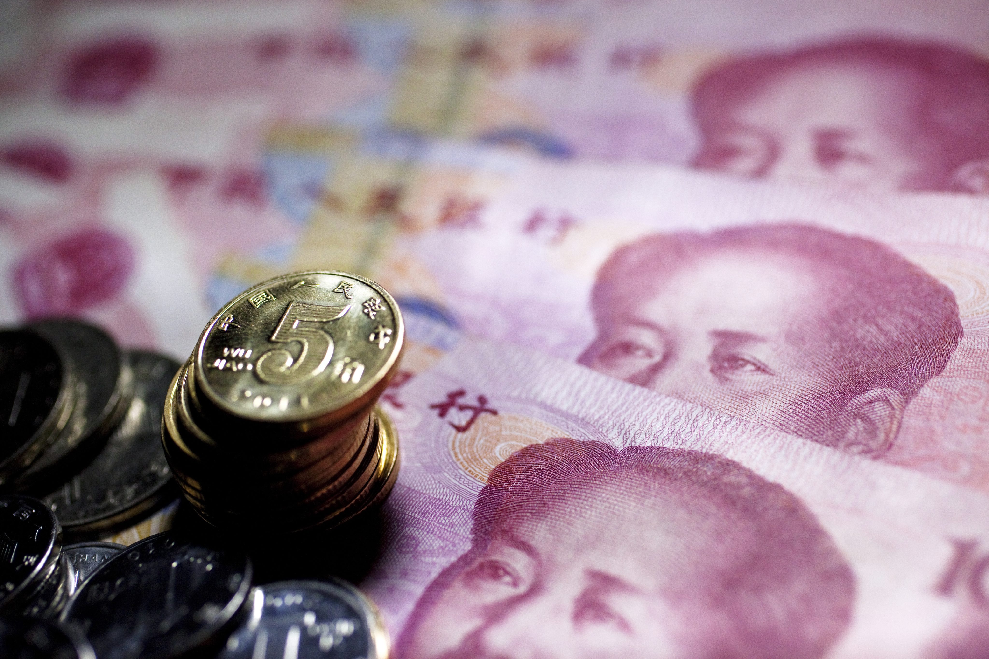 Chinese yuan bank notes and coins as the currency weakened against the dollar after US Fed chair Janet Yellen said interest rate increases are likely later in the year. Photo: EPA