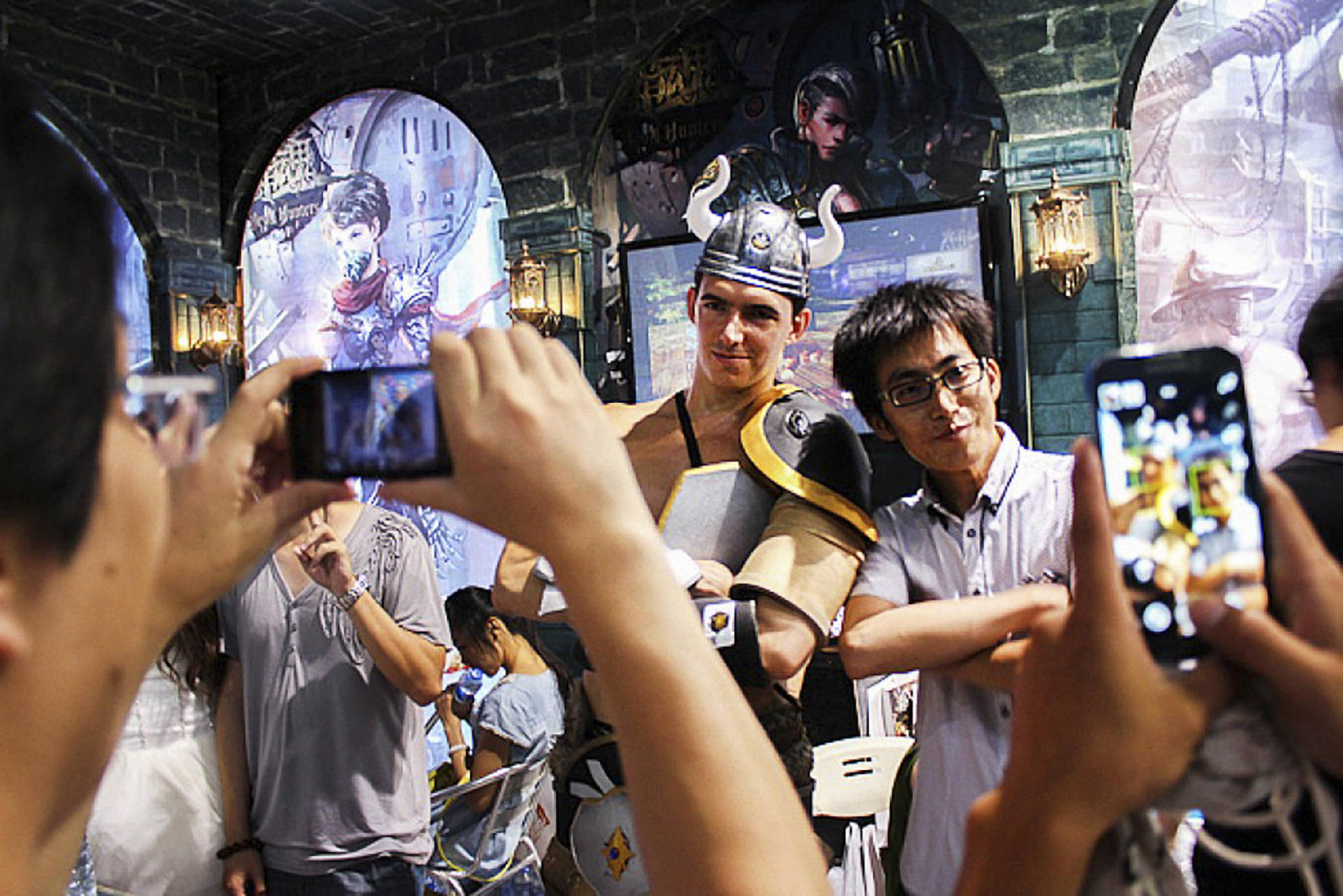 Gaming fans pose for photos at a convention in Shanghai. China is set to overtake the US as the world's biggest mobile gaming market next year, according to an industry forecast. Photo: SCMP Pictures